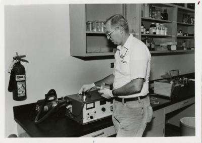 Dr. William Hess placing disc flower (on stage) into the sputter coater