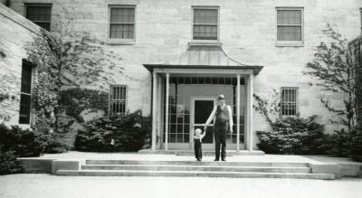 Administration Building, man and child in front of entrance