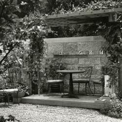 May T. Watts Reading Garden, pergola with clay tiles commemorating botanists along shelf on wall