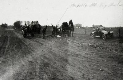 Building roads, workers with horse-drawn wagons and equipment