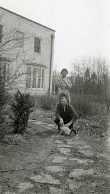 Clarence and Margaret Godshalk outside with several of their puppies