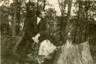 Clarence E. Godshalk sitting on a fallen oak in the woodlands, north of Lake Marmo