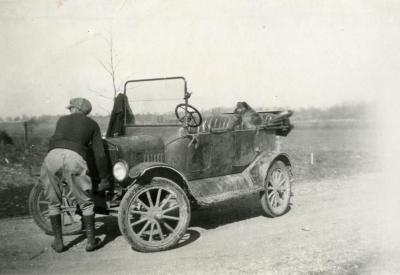Clarence E. Godshalk and his dog, Punch, with Joy Morton's castoff Model T car