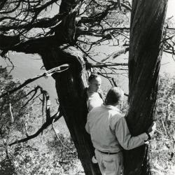Dr. Marion T. Hall with Dick Young leaning against 850 year old juniper along bluffs of the Fox River