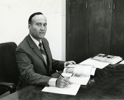 Marion T. Hall at his desk