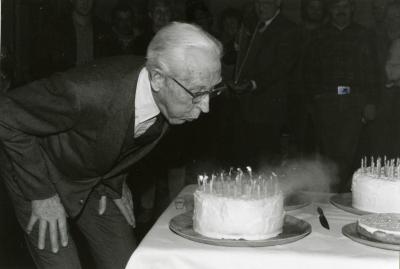 Clarence E. Godshalk's 90th birthday celebration scrapbook: Clarence Godshalk blowing out 90 candles on his birthday cake