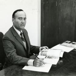 Marion T. Hall at his desk