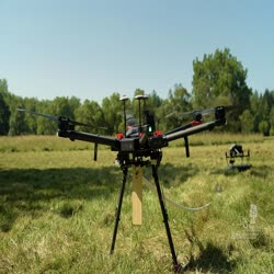 Research Experience for Undergraduates (REU) Student and Arboretum Staff Flying Drone 