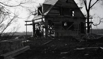Clarence Godshalk's first Arboretum house under construction, front view with John and girls next to house
