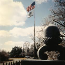 Flag pole and stone acorn at Arboretum entrance