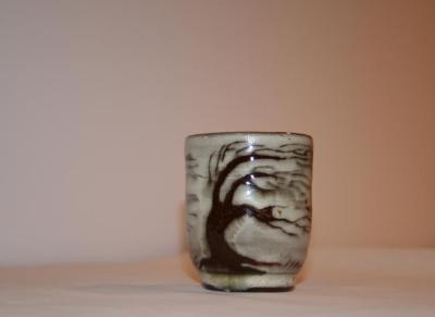 small ceramic container with brown under glazed and windblown tree design