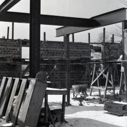  Administration Building construction, view from inside construction site showing crossbeams and brick work in winter