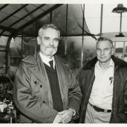 Ray Schulenberg in greenhouse with other person
