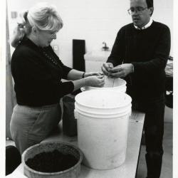 Mike Spravka and volunteer cleaning seeds in Research Building basement in preparation for seed exchange