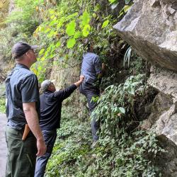 Andrew Gapinski, Kang Wang, and Peter Zale collecting from a cliff face
