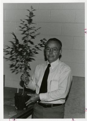 George Ware holding plant indoors