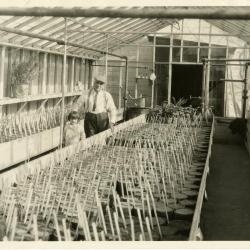 John Van Gemert in greenhouse with daughter, Janet