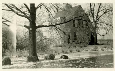 Clarence Godshalk's first Arboretum house, exterior side view of front from frozen Joliet Road, winter