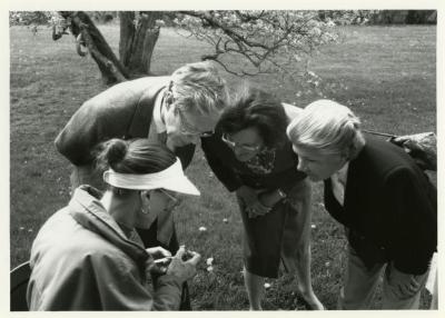 Arbor Day/Week, Ruth Luthringer and two others examining flower with a lens