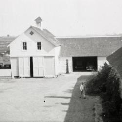 South Farm as it looked before 1935, man walking near building in courtyard
