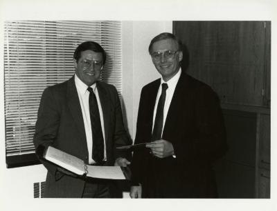 Old business manager, Donald Heldt (left), with new business manager, Timothy Wolkober, in office